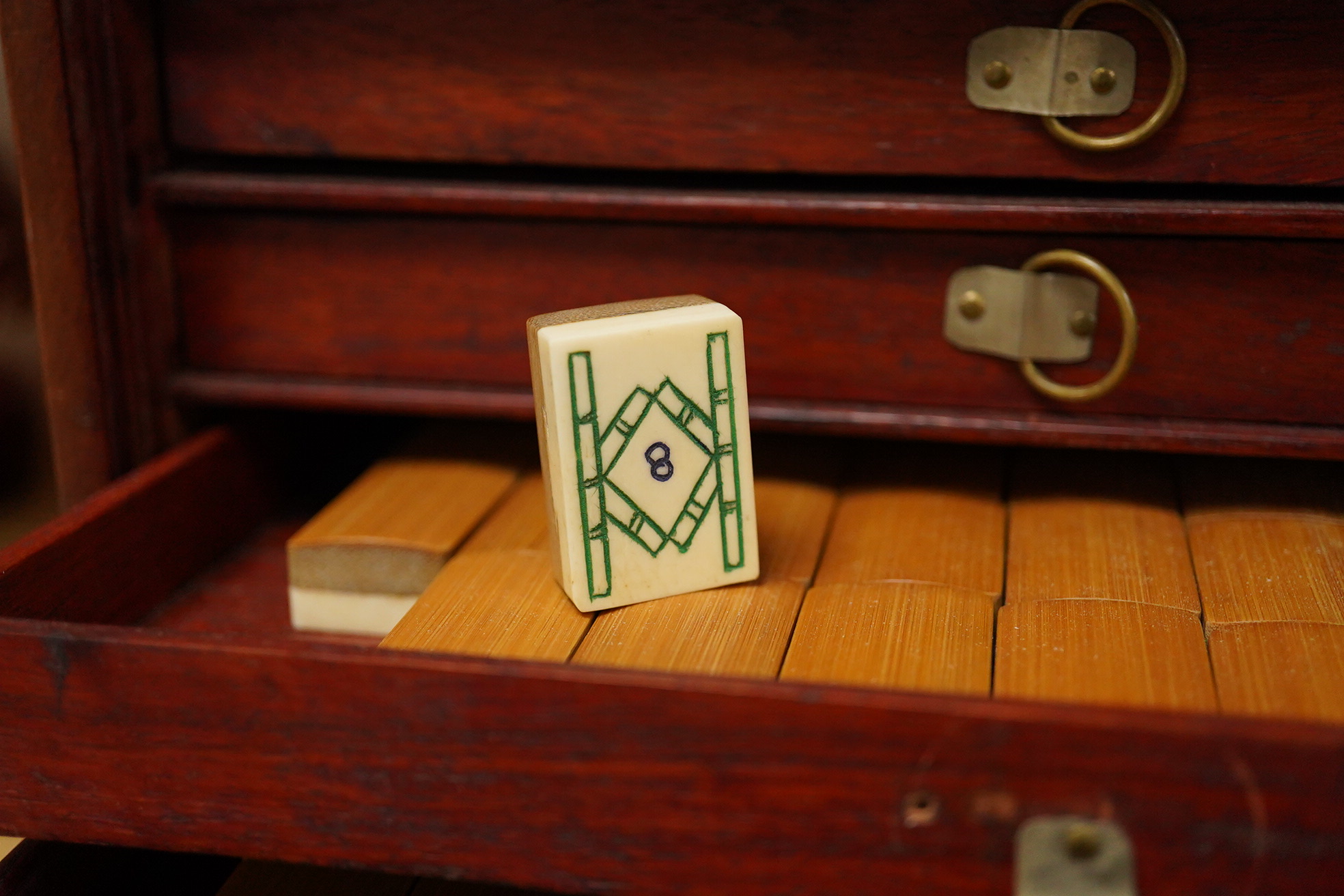 A Mah jong set an related book 24cm x 16.5cm high